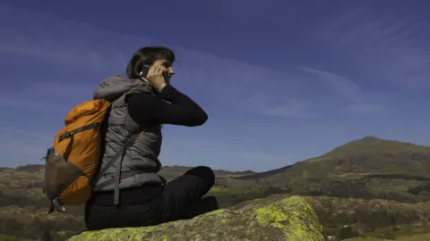Getty Images Using a phone in a remote location - stock image
