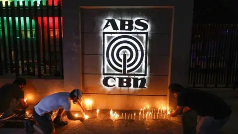 EPA Filipinos light candles in symbolic solidarity outside ABS-CBN network headquarters in Quezon City, Metro Manila, Philippines, on 5 May 2020