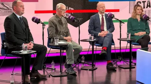 Four people in chairs