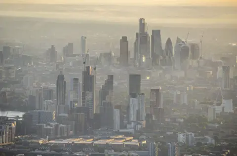 Jason Hawkes Misty morning view over Vauxhall with the City of London in background