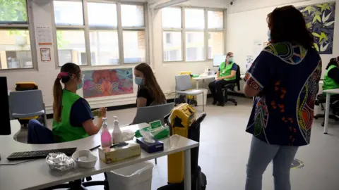 EPA A member of the community receives a dose of COVID-19 vaccine at the Kimberwalli Aboriginal COVID-19 vaccination Hub in Whalan, New South Wales, Australia, 28 September 2021.