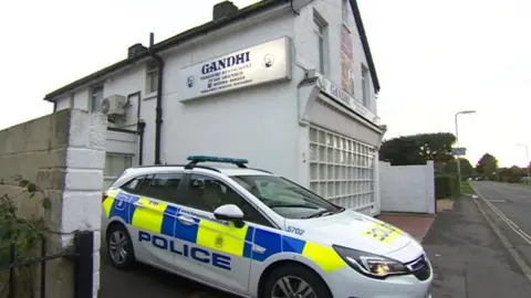 BBC Police car outside Gandhi restaurant