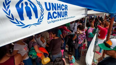 Getty Images Venezuelan migrants apply for refugee status at the Peruvian border on June 14, 2019