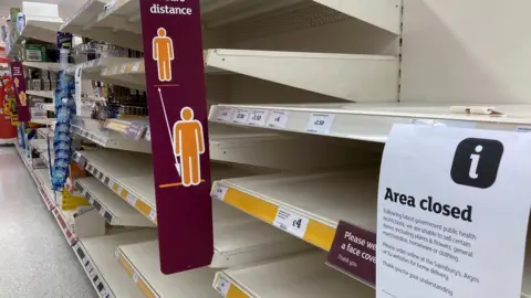 Reuters Empty shelves in a supermarket in Tenby