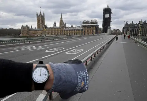  Toby Melville / Reuters A photographer wearing a watch at noon in front of the Houses of Parliament on Westminster Bridge, in London, UK