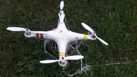 Droptec Drone on ground tangled in net