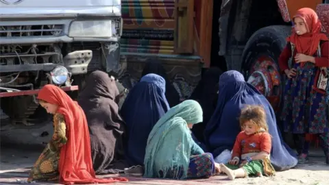 EPA Afghan refugee women and children sit at a registration centre after arriving from Pakistan near the Afghanistan-Pakistan border in Spin Boldak district of Kandahar province, Afghanistan, 28 November 2023