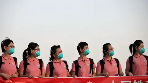 AFP Chinese medics in face masks at the main airport in Abuja, Nigeria - Wednesday 8 April 2020