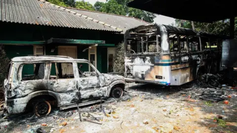 NurPhoto/Getty Images Burnt-out vehicles outside the Sri Lankan president's private residence in Colombo on Friday