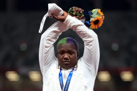 Reuters Shot put silver medallist Raven Saunders of the United States gestures on the podium