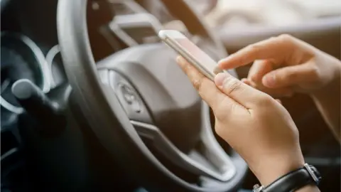 Getty Images Driver uses parking app
