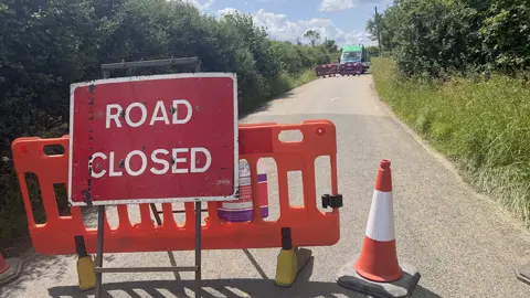 John Fairhall/BBC The road closed sign near the burst water main in Stansfield, Suffolk