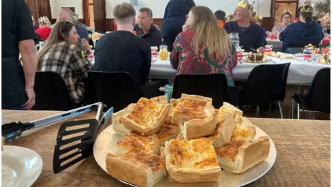A plate of thick cut homemade quiche baked by Storehouse volunteers