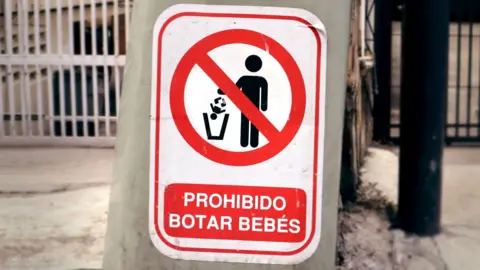 Guillermo D. Olmo A sign reading "Dumping babies is forbidden "