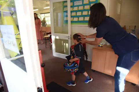 AFP Child returns to his classroom in June