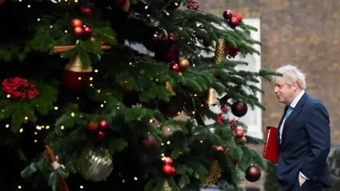 Reuters Boris Johnson walks past the Downing Street Christmas tree as he returns to No 10 after a cabinet meeting at the Foreign and Commonwealth Office