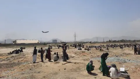 Getty Images Afghans have been waiting near the airport as they try to leave Kabul