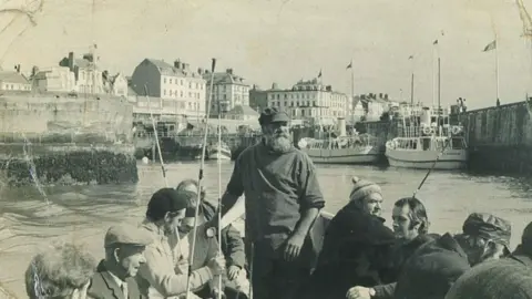 ERYC Black and white photograph of local fisherman Leonard Broadbent with a beard, cap and fishing jumper