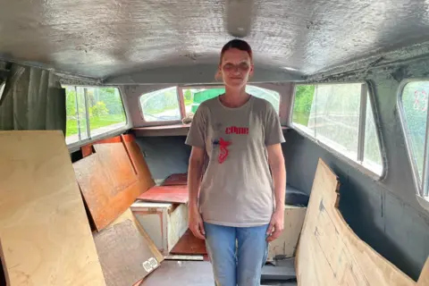 Jolita standing inside her boat