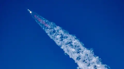 Starship blasting off in blue sky