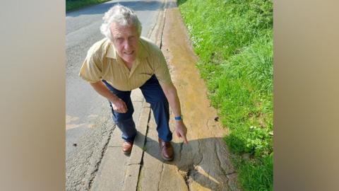 Councillor Steve Kay inspects the pedestrian footpath between Lingdale and Boosbeck, in East Cleveland