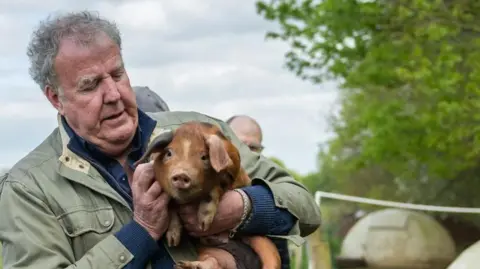 Amazon Prime Jeremy Clarkson holding a baby pig