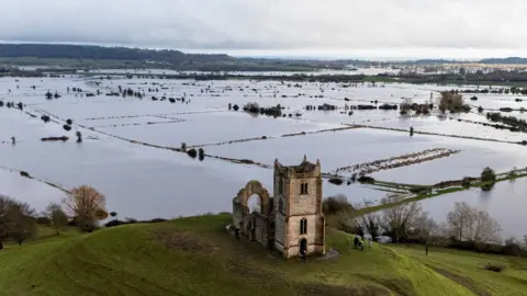 Burrow Mump standing above flooding fields in the Burrowbridge area of Somerset. The photo is from 10 February 2026 after a prolonged period of wet weather including Storm Chandra.