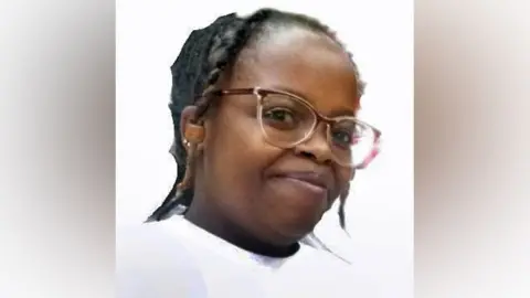 Rose Njeri, in glasses and white T-shirt