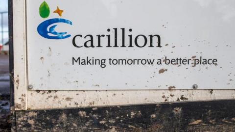 A Carillion sign, with mud splattered at its base