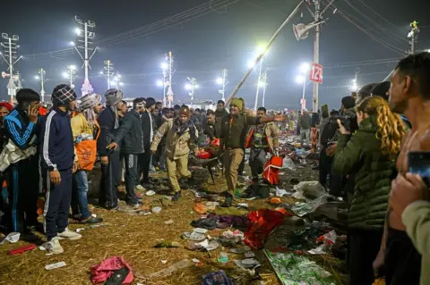 AFP Police personnel carry victims of stampede amid the ongoing Maha Kumbh Mela festival in Prayagraj on January 29, 2025