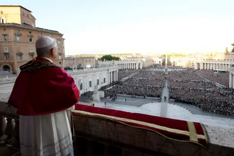 Reuters Pope Leo XIV stands on the balcony overlooking St Peter's Square during his first appearance as pontiff