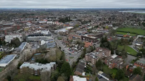 Getty Images Walton is seen in an aerial shot with low rise buildings, some houses and playfields with a road going through the middle of it.