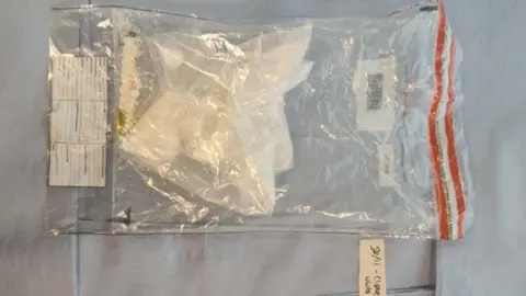 Greater Manchester Police White powder can be seen inside a clear plastic evidence bag in a photo taken by police. 