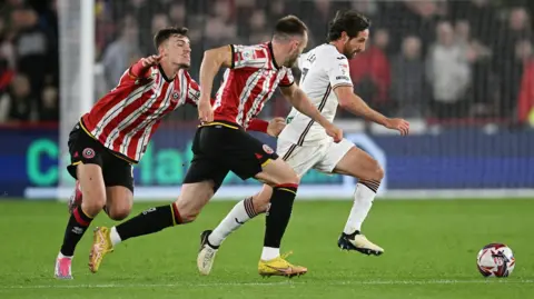 Swansea City midfielder Joe Allen runs with the ball against Sheffield United