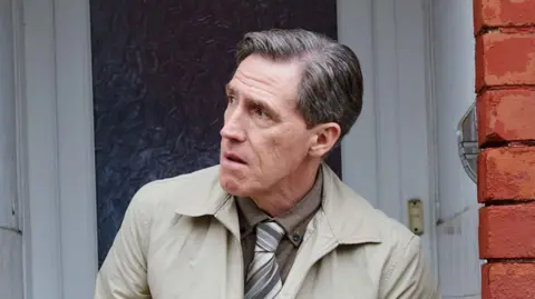 Uncle Bryn stood outside his front door