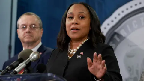 Getty Images Fani Willis announces charges against Donald Trump and 18 associates