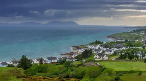Getty Images Gairloch is a small coastal village of white-walled houses.