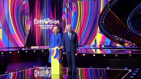 Reuters The King and Queen Consort stood on the Eurovision stage with a button