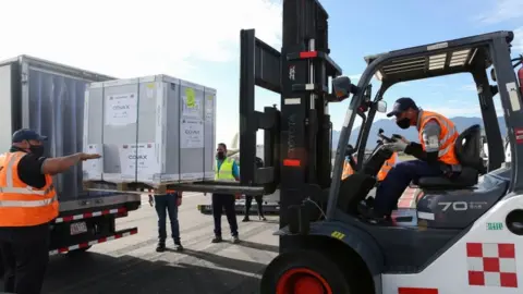 Reuters Workers load a container holding doses of the AstraZeneca's vaccine