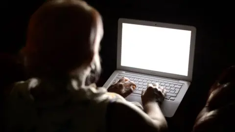 PA Picture of woman in front of a computer