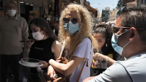 AFP Shoppers wearing masks at Mahane Yehuda market, Jerusalem (file photo)