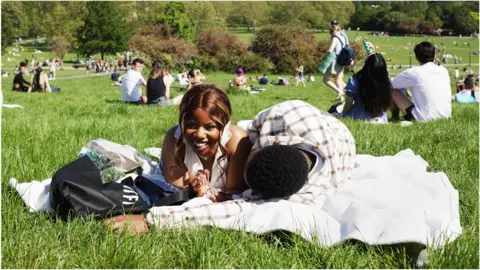 Getty Images Enjoying the sun in a park