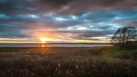 Nick Dallimore  A moody sunset over the Usk Estuary at Newport Wetlands