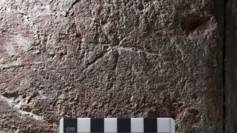 Dr Antonia Thomas, UHI Star shape scratched in pillar