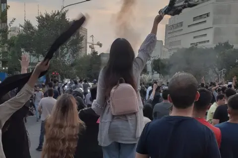 Twitter File photo showing women without headscarves protesting in Iran on 21 September 2022