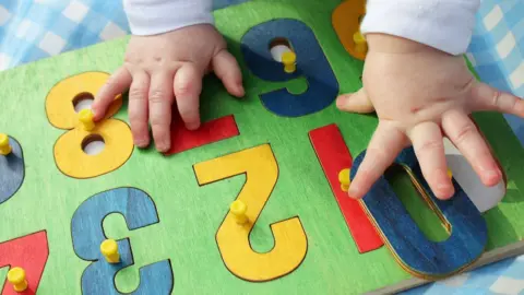 Getty Images Child with number board