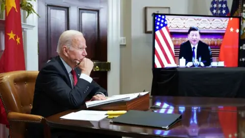 AFP Biden sitting at table with Xi on a screen