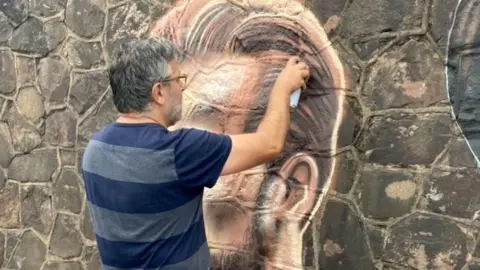 James Bennett N4T4 working on the mural