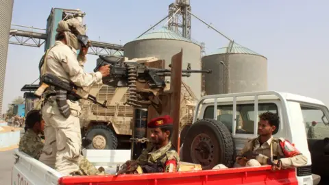 AFP Pro-government soldiers at Yemen's Red Sea Mills company in Hudaydah (22 January 2019)