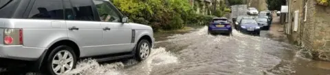 Burton Bradstock Parish Council Cars on flooded road in Dorset